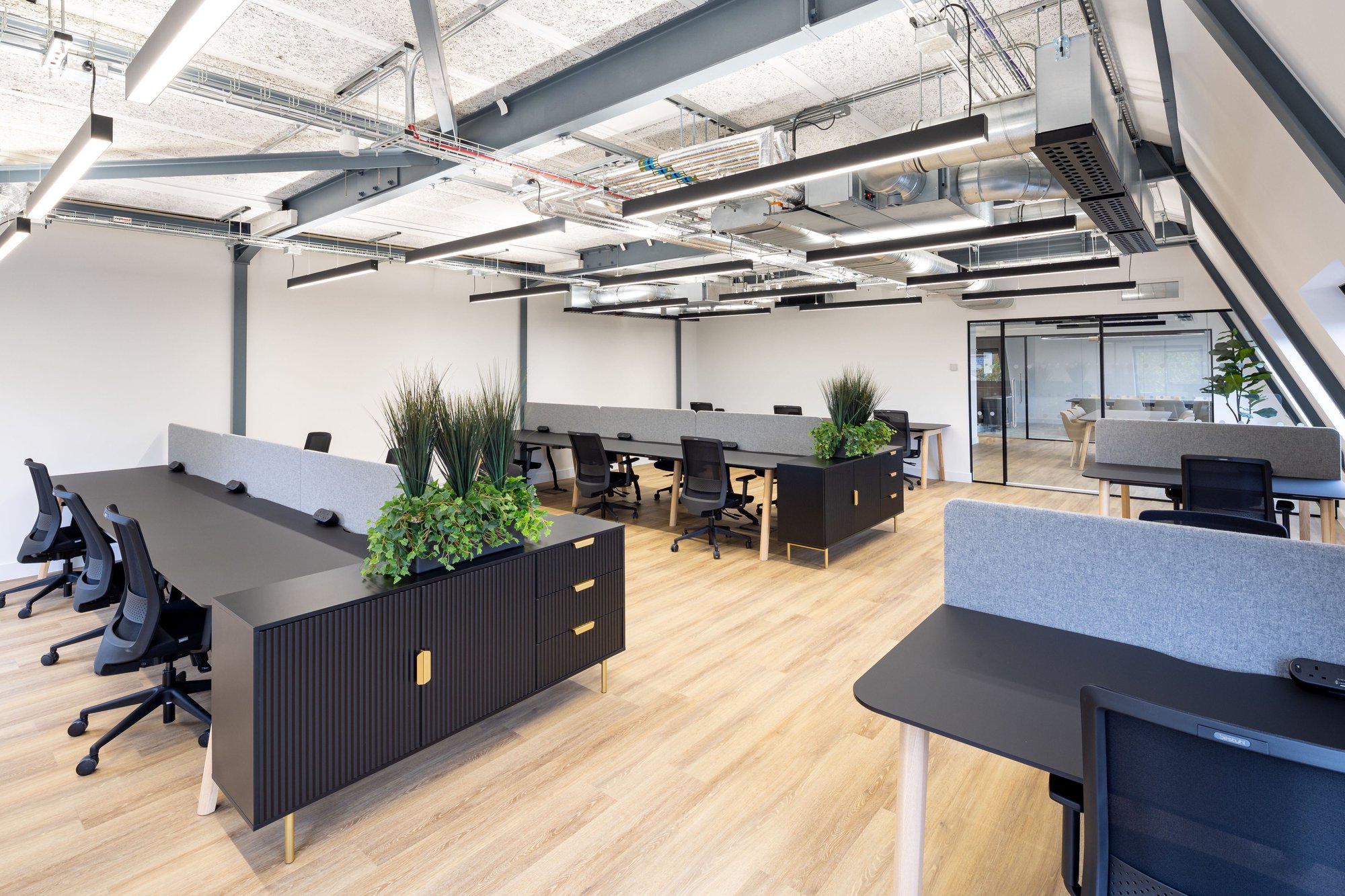 open plan office with linear lighting and exposed services
