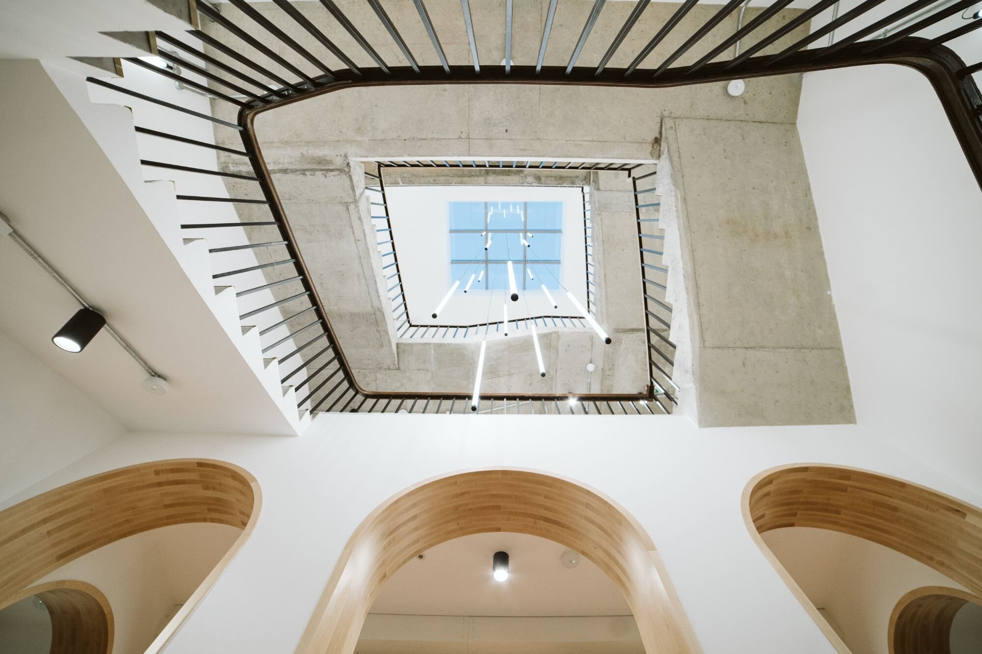 Office and architectural lighting for an office development with exposed ceilings at 13-20 Settles Street, London.
