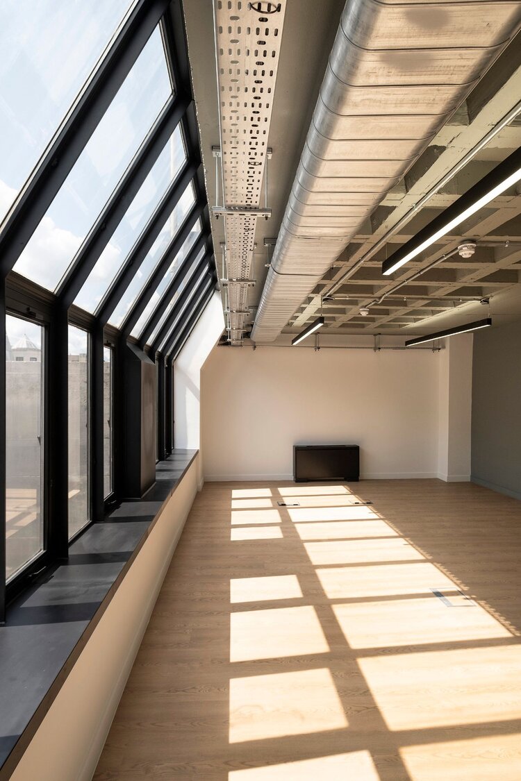 Office lighting for a CAT A fitout with concrete coffered slabs at 390 Strand, London.
