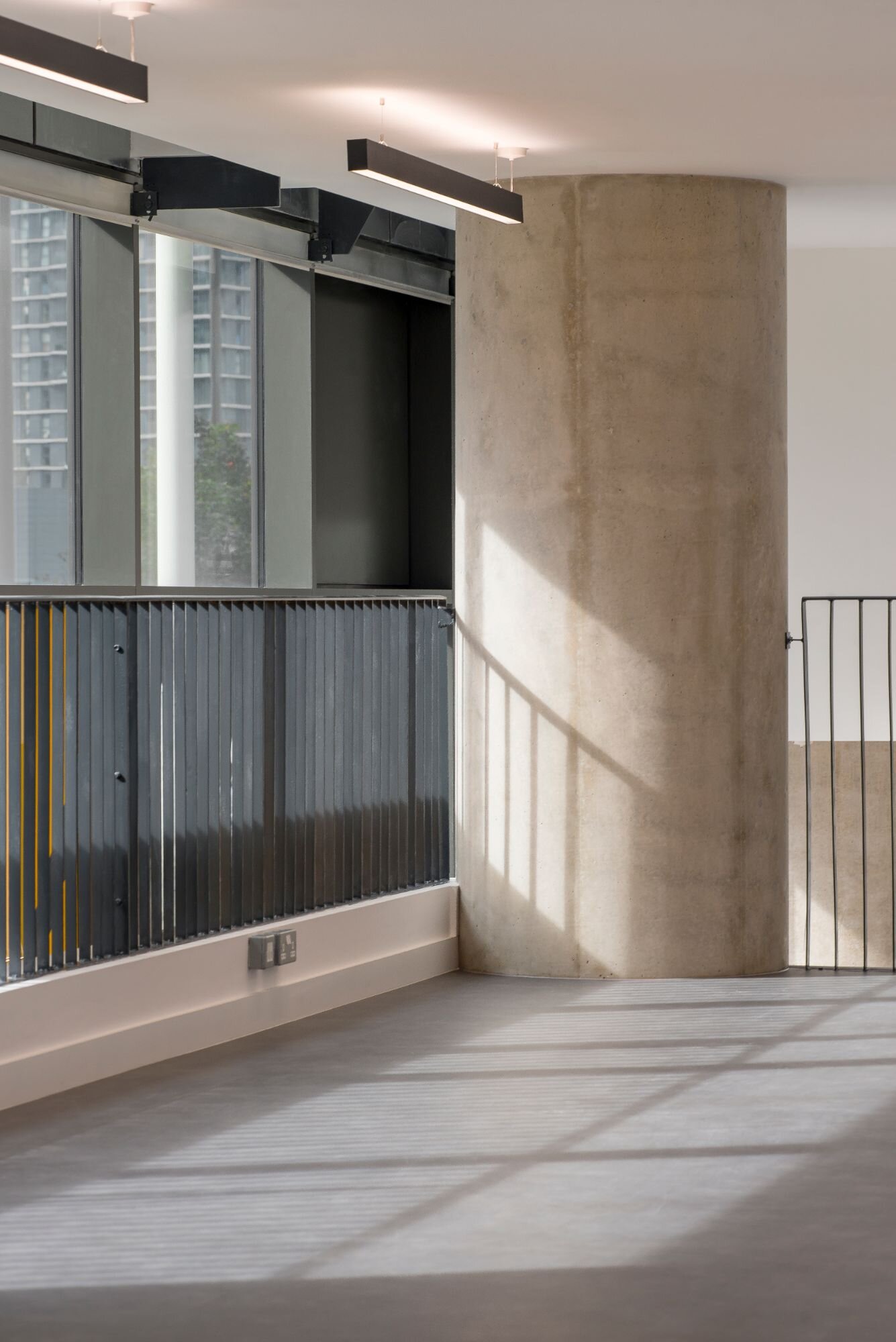 Contemporary office lighting for a CAT A fitout at Stratosphere Tower, London.