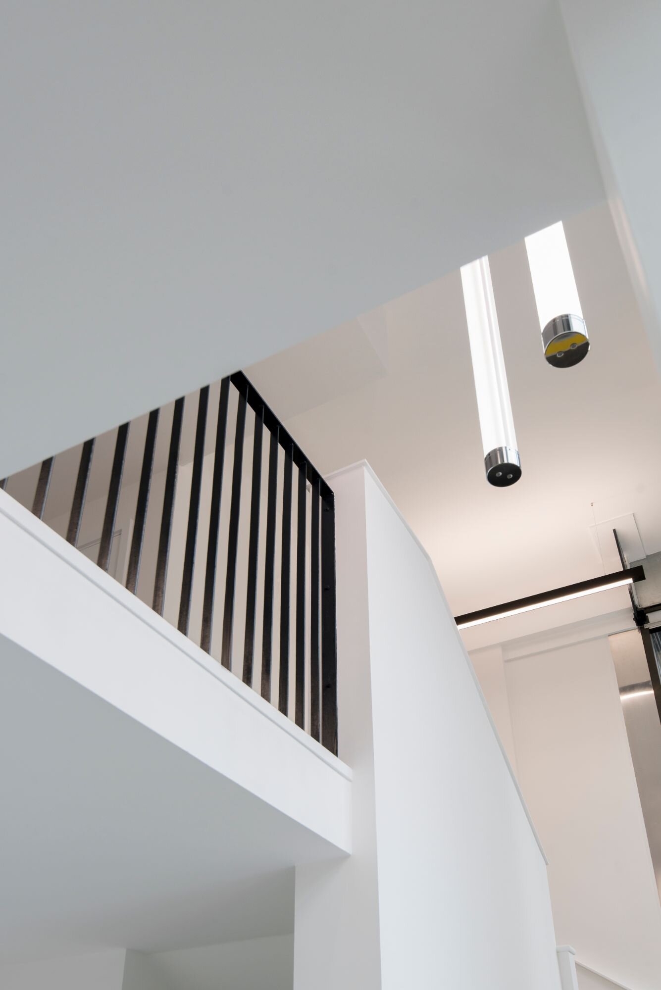Contemporary office lighting for a CAT A fitout at Stratosphere Tower, London.