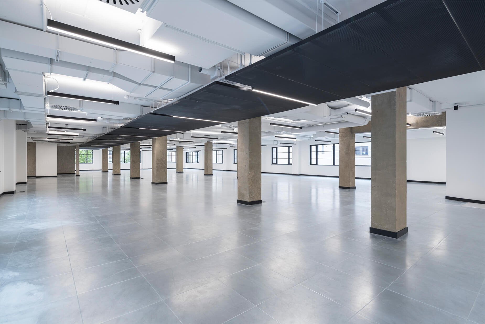 Fast-paced contemporary CAT A fitout with exposed concrete soffits at 44 Featherstone Road, London.