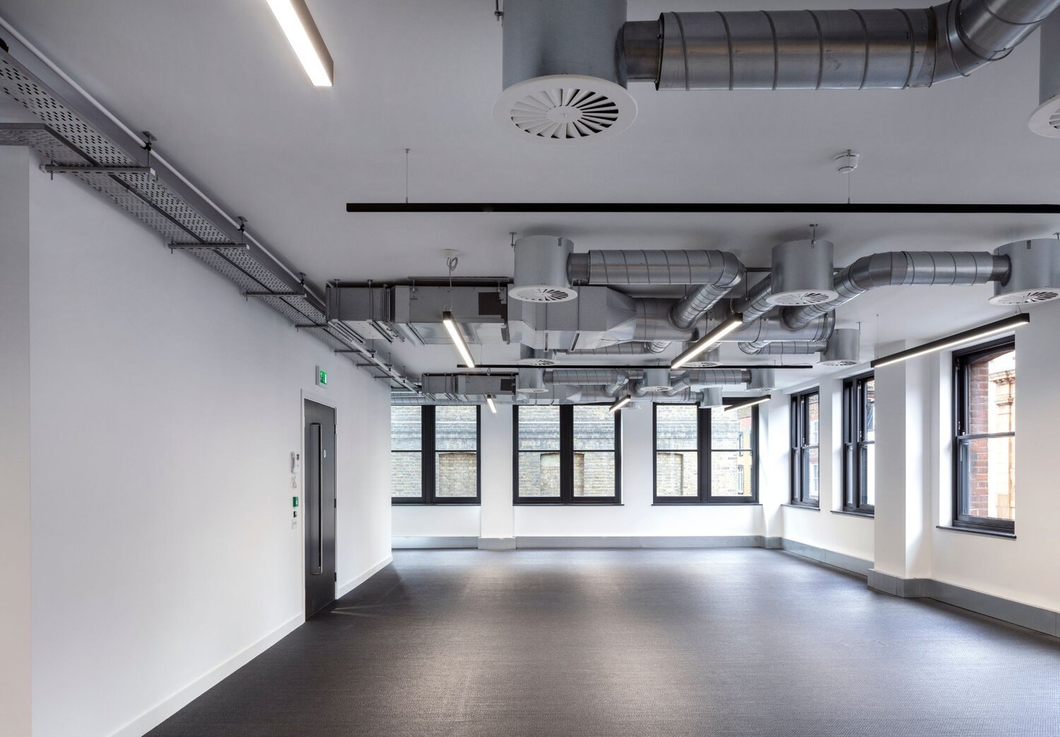 Office architectural lighting for a media style CAT A fitout at 82-84 Berwick Street, London.