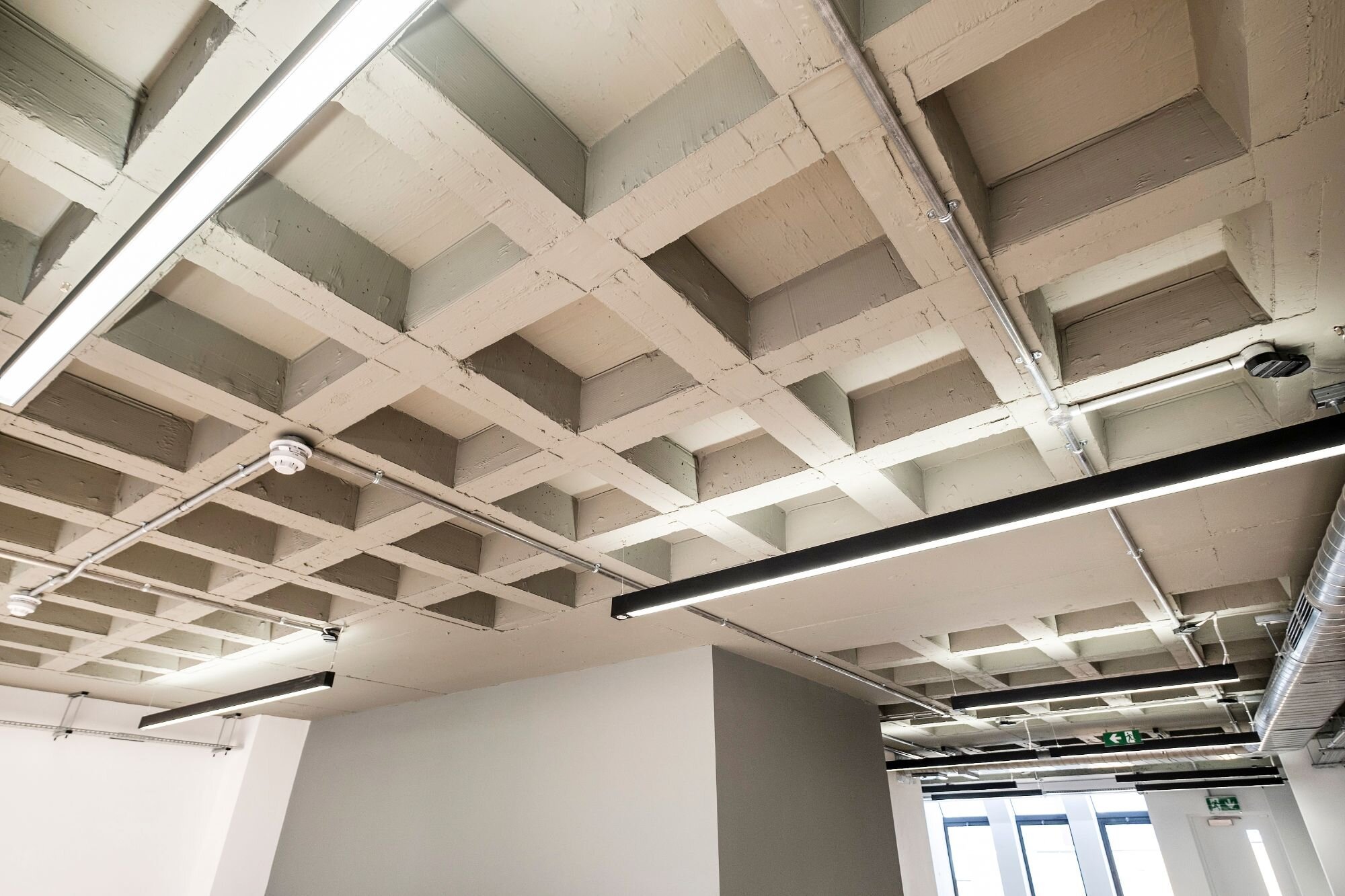 Office lighting for a CAT A fitout with concrete coffered slabs at 390 Strand, London.