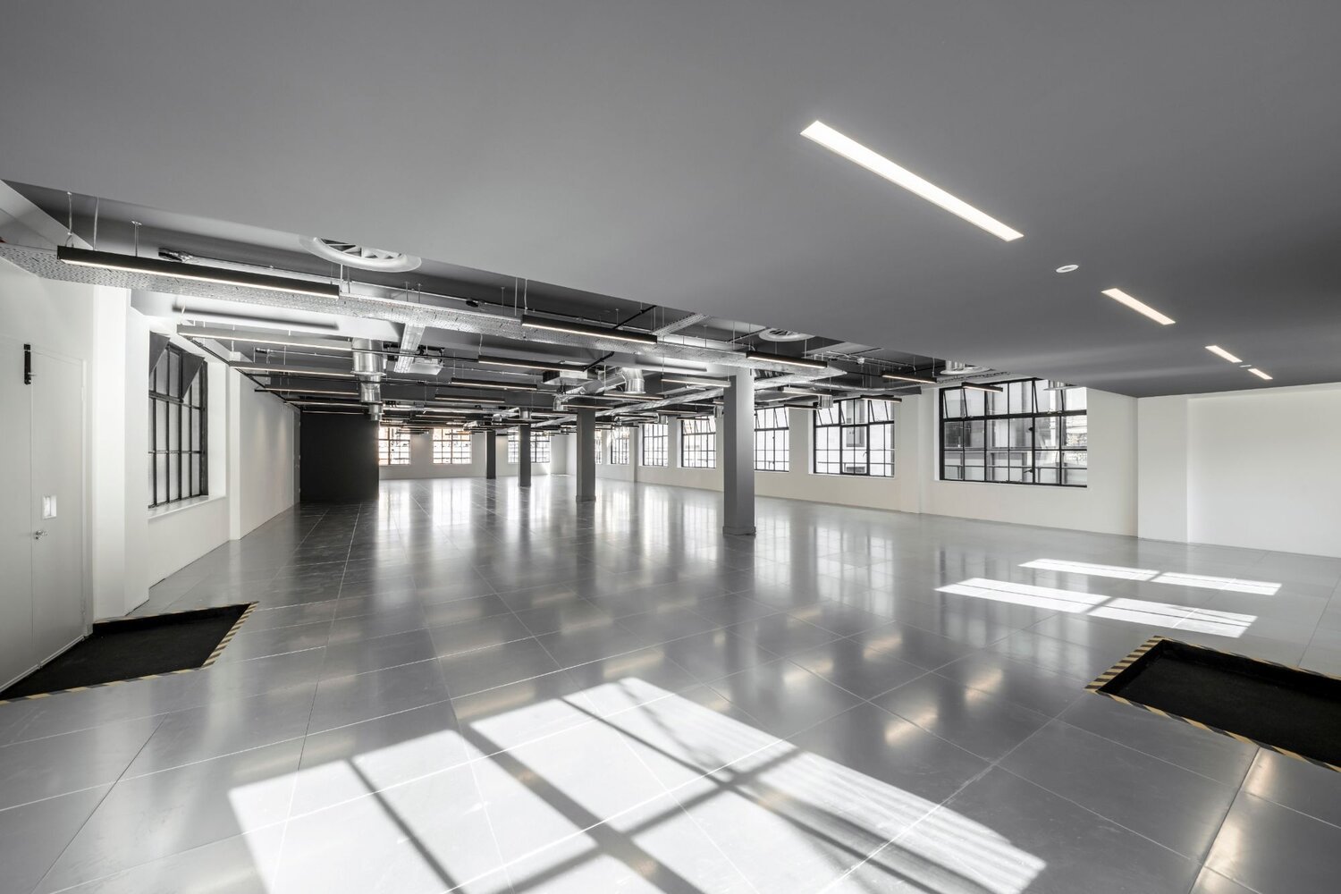 Office lighting for an industrial style CAT A fitout at 11 Old Jewry, London.