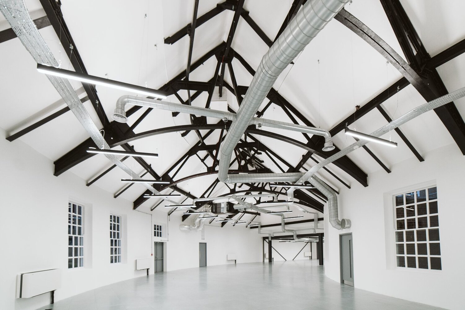 Office and architectural lighting for an office development with exposed ceilings at 13-20 Settles Street, London.