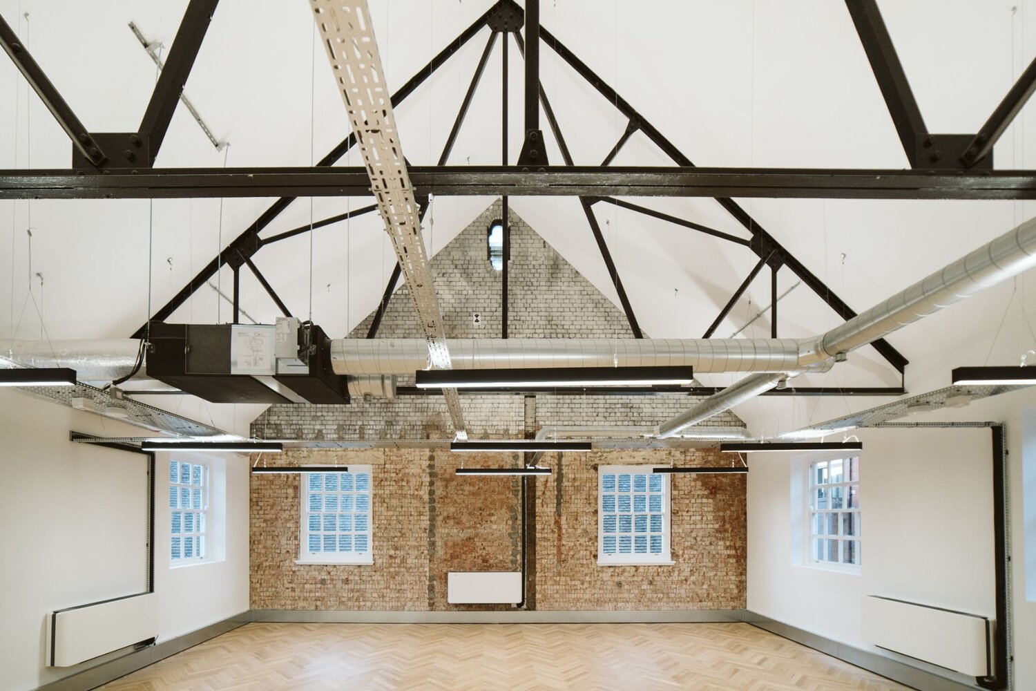 Office and architectural lighting for an office development with exposed ceilings at 13-20 Settles Street, London.