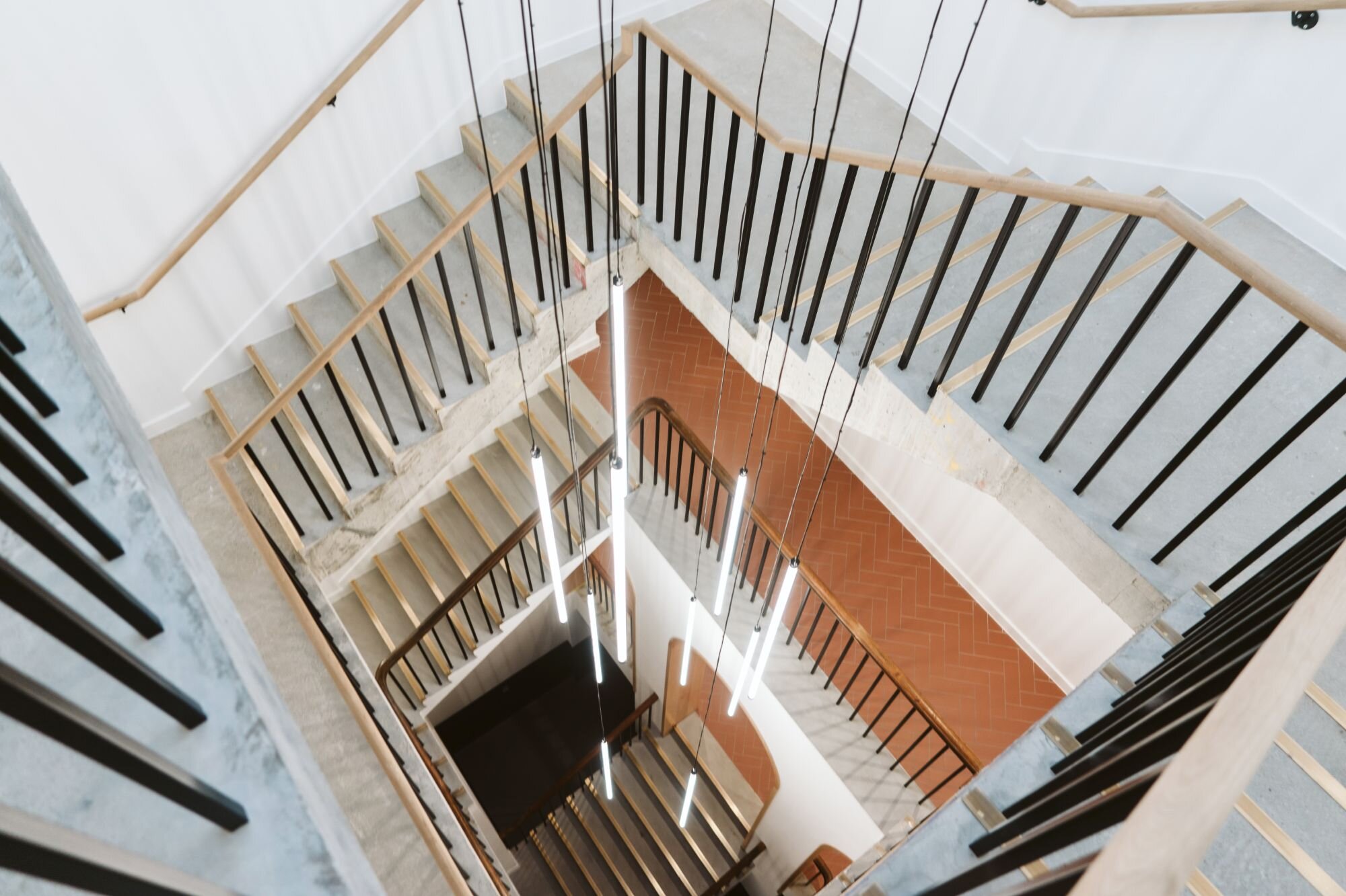 Office and architectural lighting for an office development with exposed ceilings at 13-20 Settles Street, London.