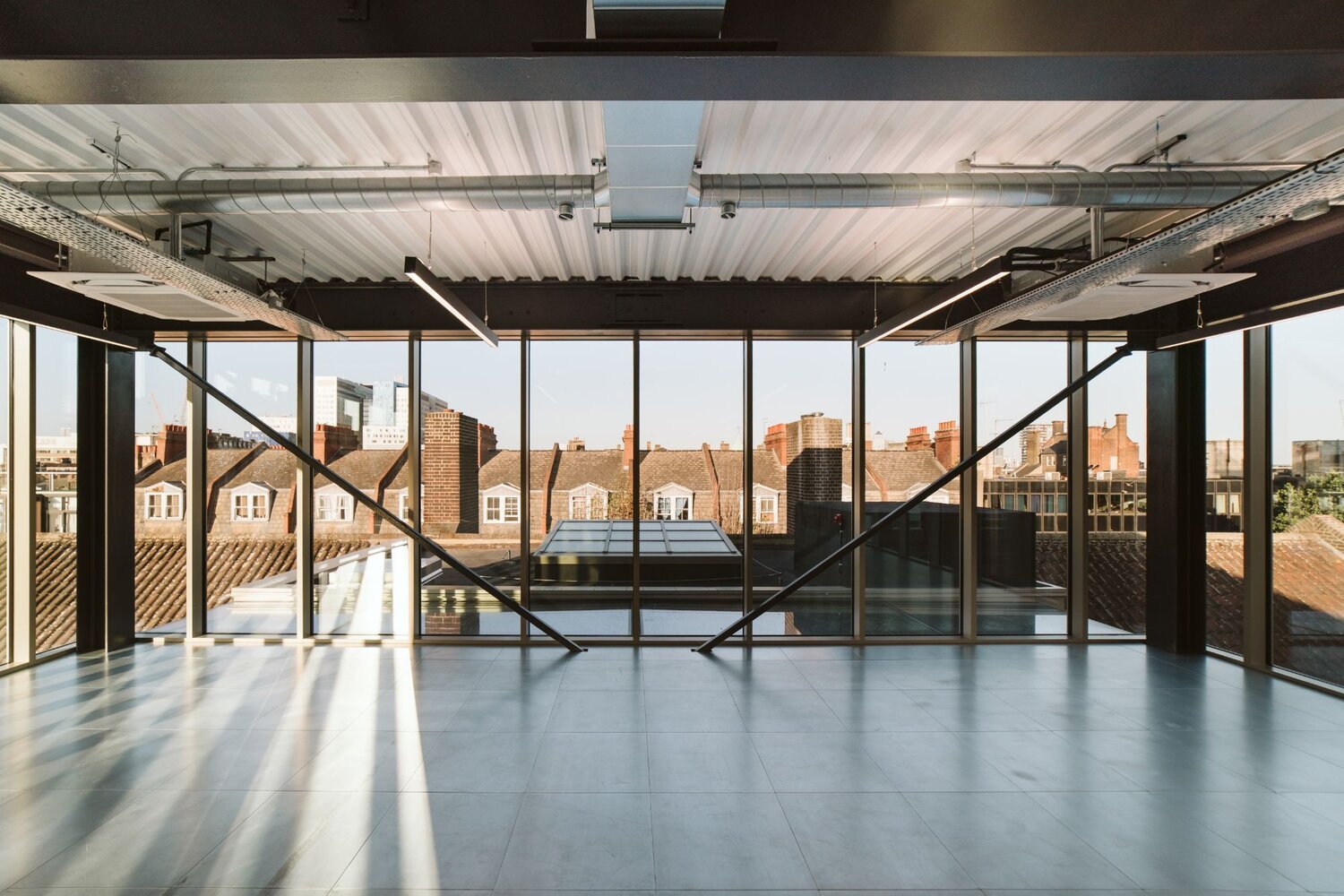 Office and architectural lighting for an office development with exposed ceilings at 13-20 Settles Street, London.