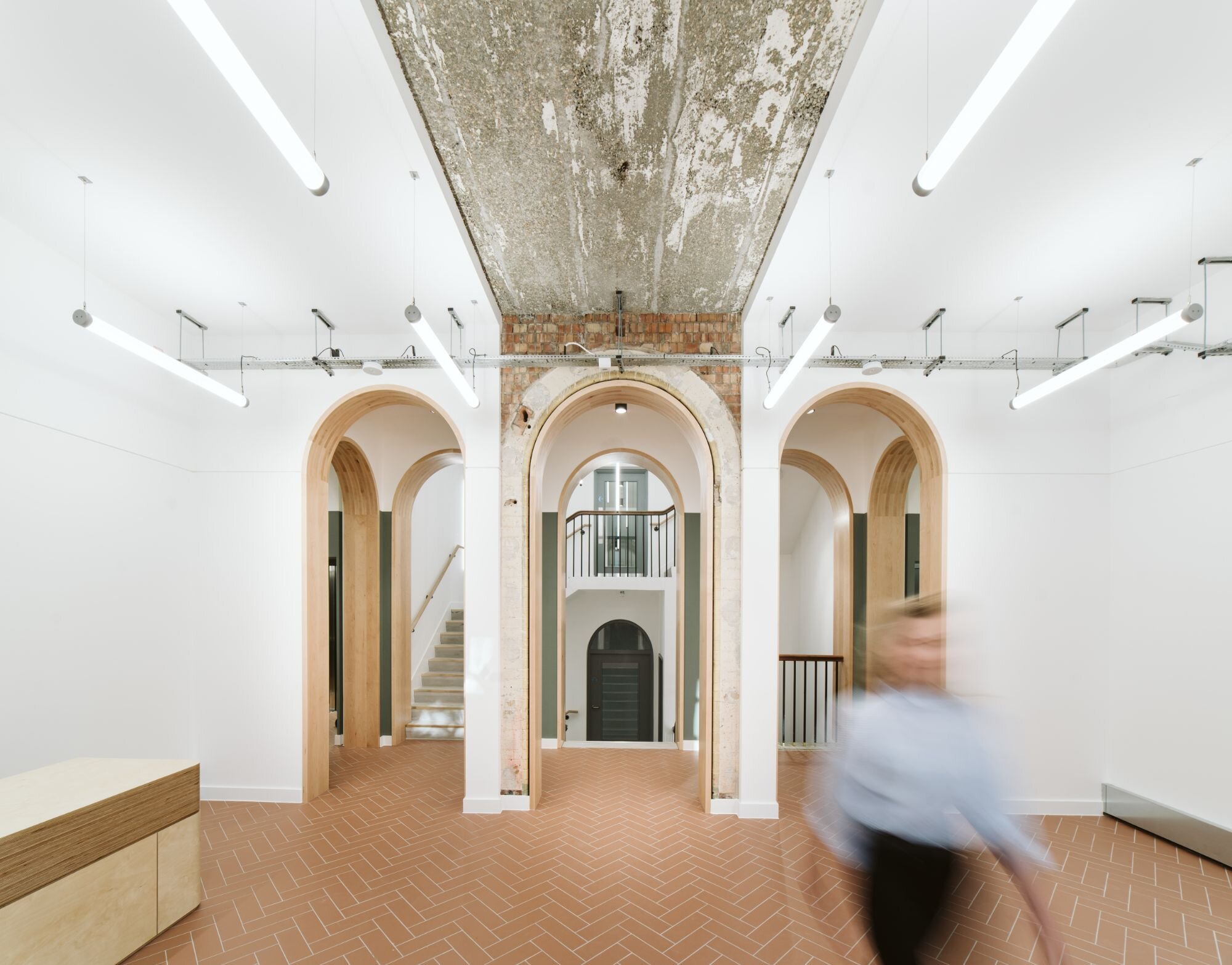 Office and architectural lighting for an office development with exposed ceilings at 13-20 Settles Street, London.