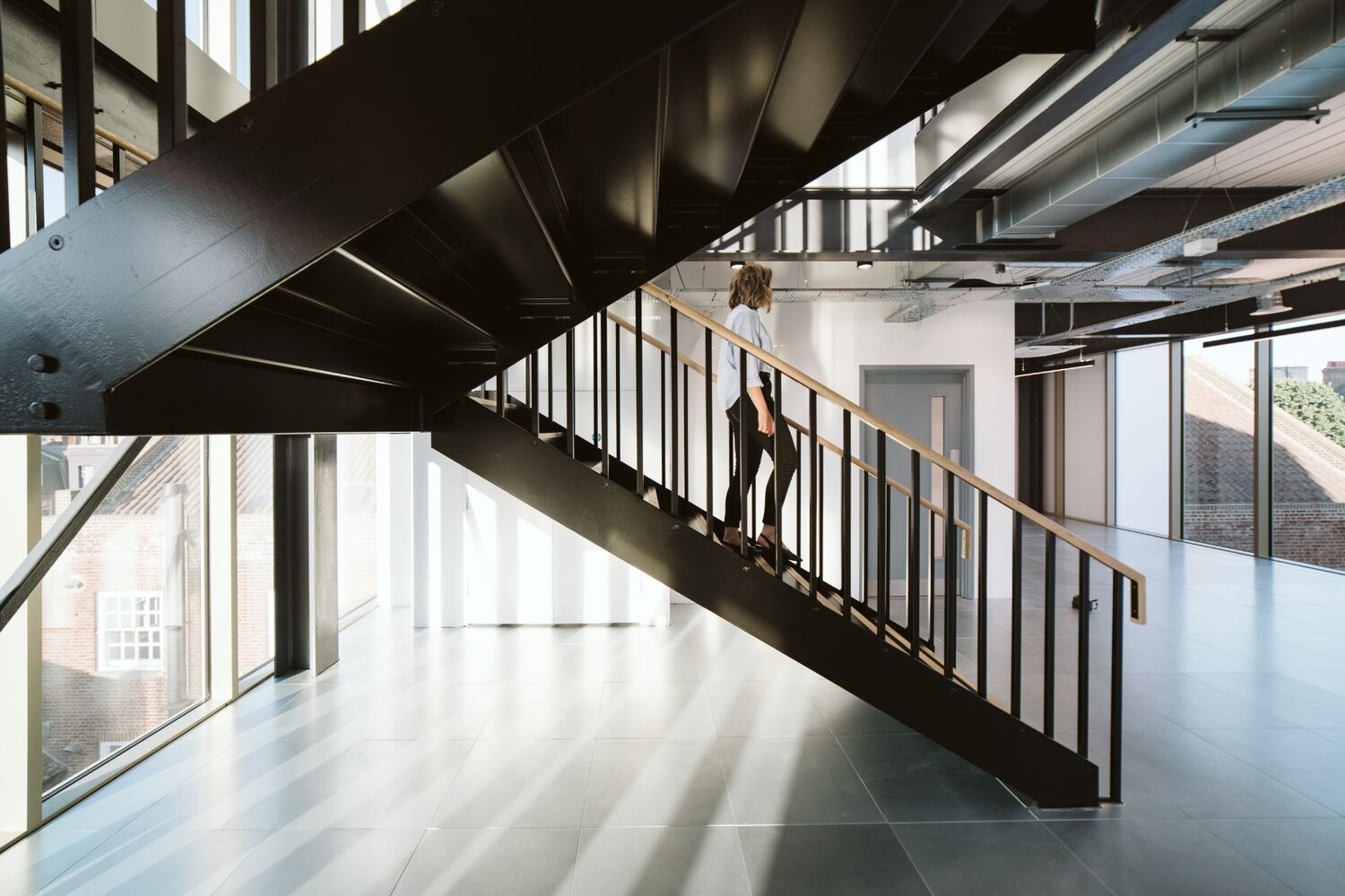 Office and architectural lighting for an office development with exposed ceilings at 13-20 Settles Street, London.