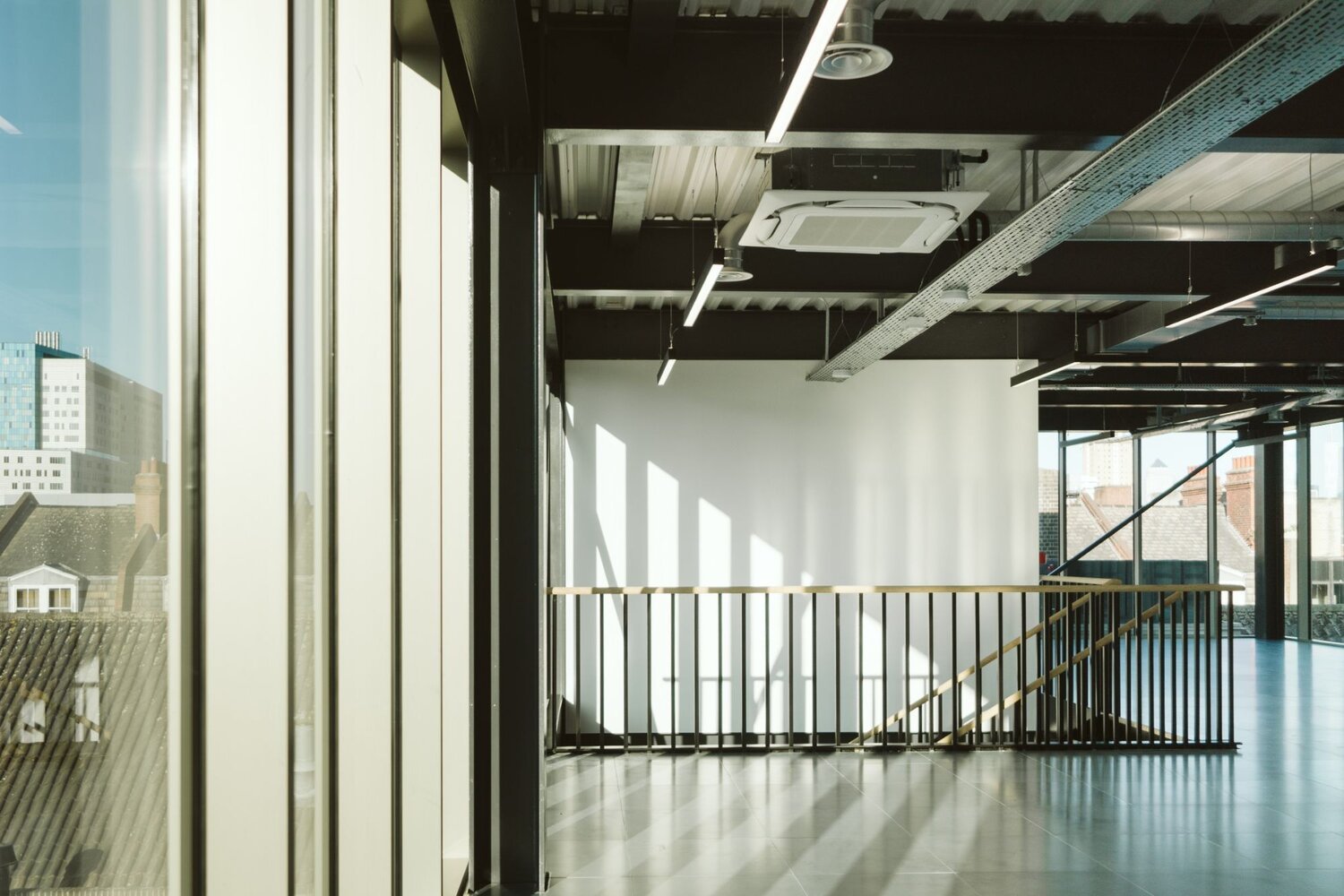 Office and architectural lighting for an office development with exposed ceilings at 13-20 Settles Street, London.