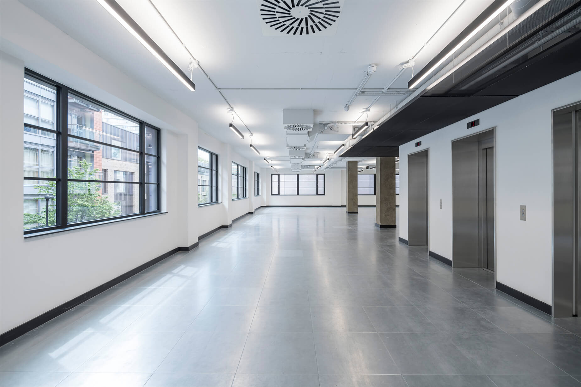 Fast-paced contemporary CAT A fitout with exposed concrete soffits at 44 Featherstone Road, London.