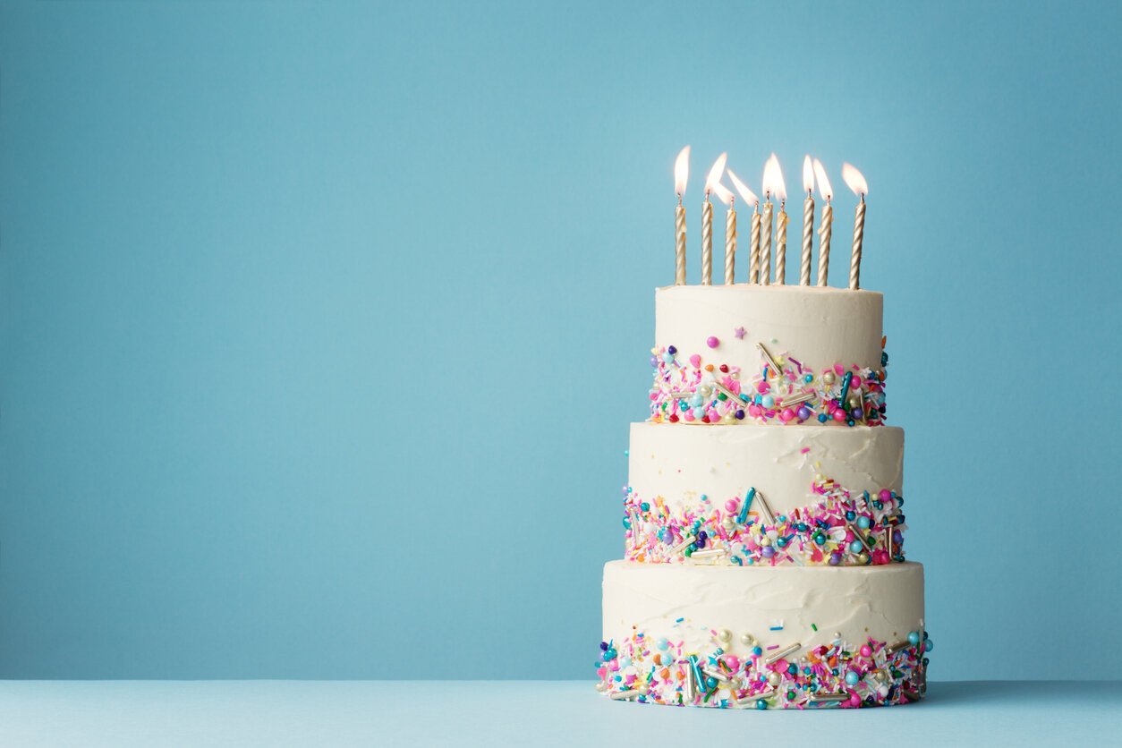 Tiered birthday cake with colorful sprinkles